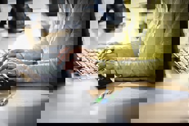 Person typing on keyboard